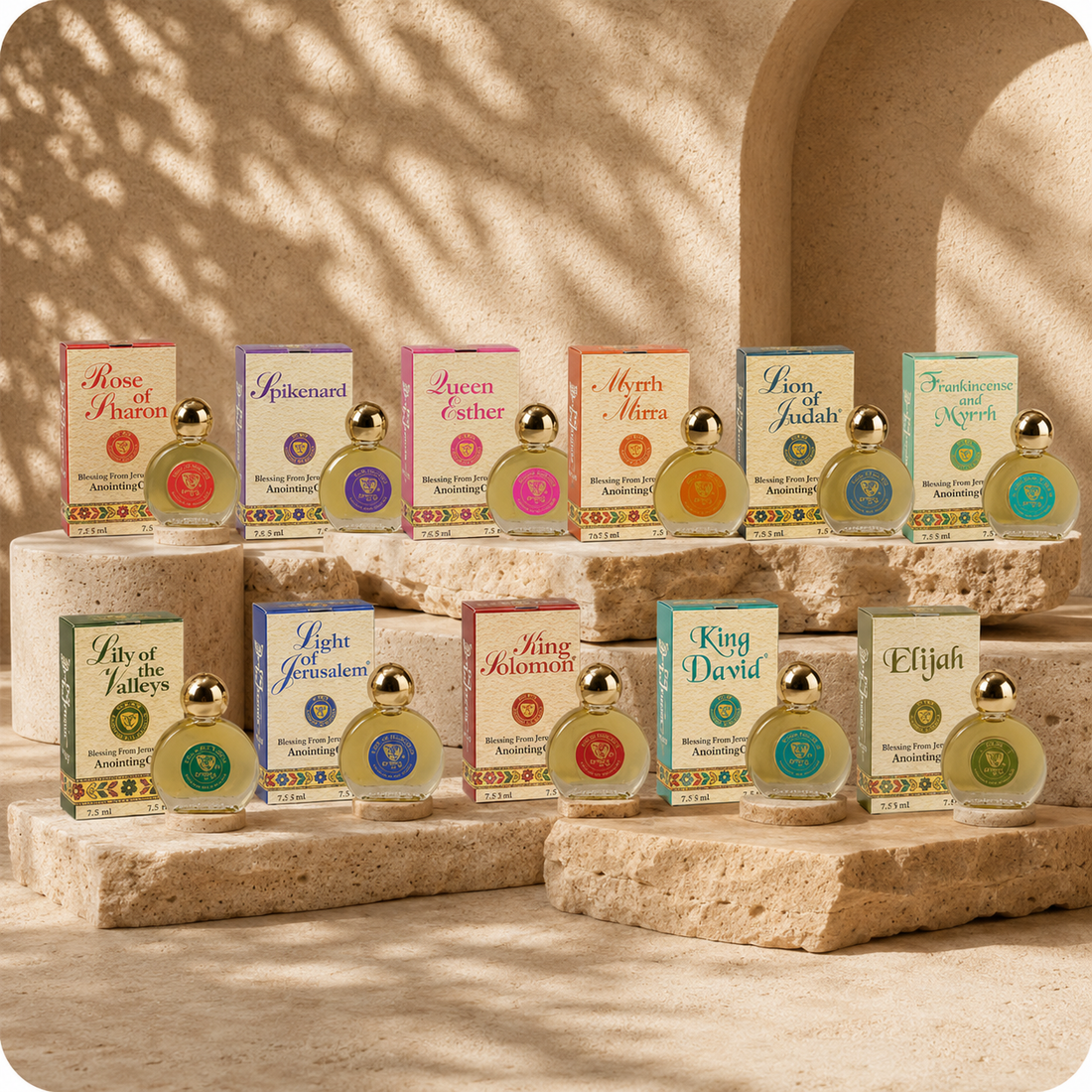 Mini Blessing from Jerusalem anointing oils collection displayed on natural stone podiums with warm sunlight and soft olive tree shadows